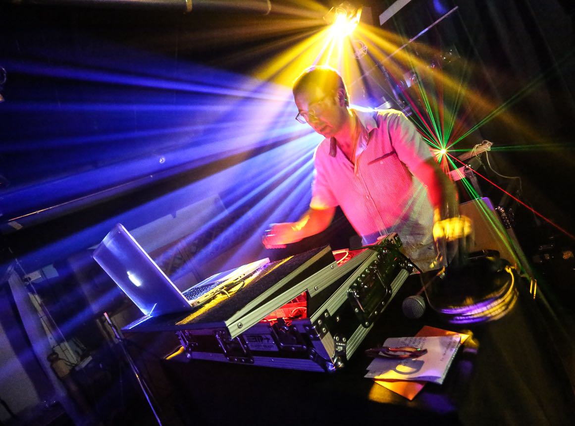 Image of party dj Nigel Peirce with lazer lighting