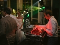 Image of a DJ standing behind the decks at a Babington House Wedding.