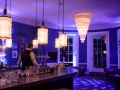 Violet LED up-lighting with DJ lighting for a wedding