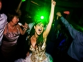 An image of a bride with her hands in the air and eyes closed.