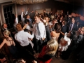 Image of a full dance-floor with everyone enjoying themselves.