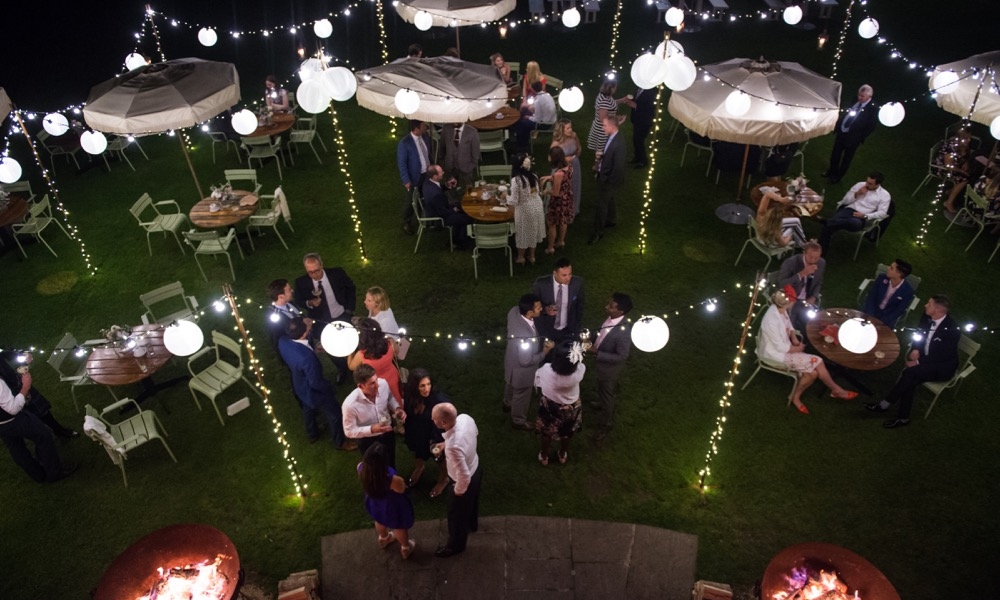 Image of a law with a lighting canopy installed for a wedding.