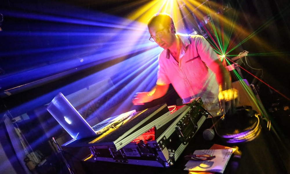 Image of party dj Nigel Peirce with lazer lighting
