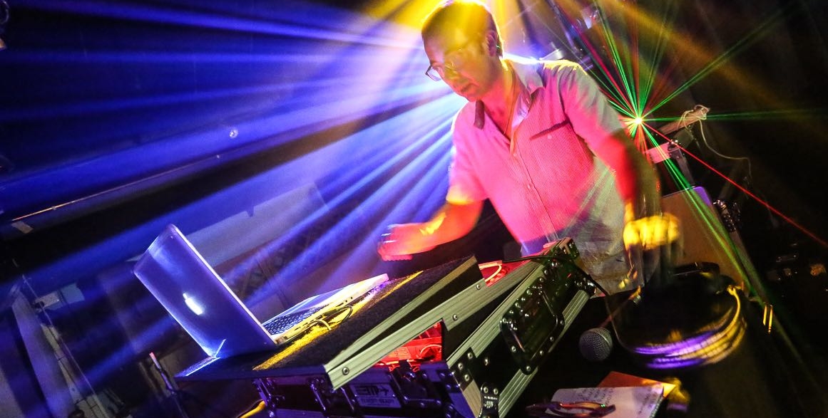 Picture of a DJ playing with a Sax and Bongo Player
