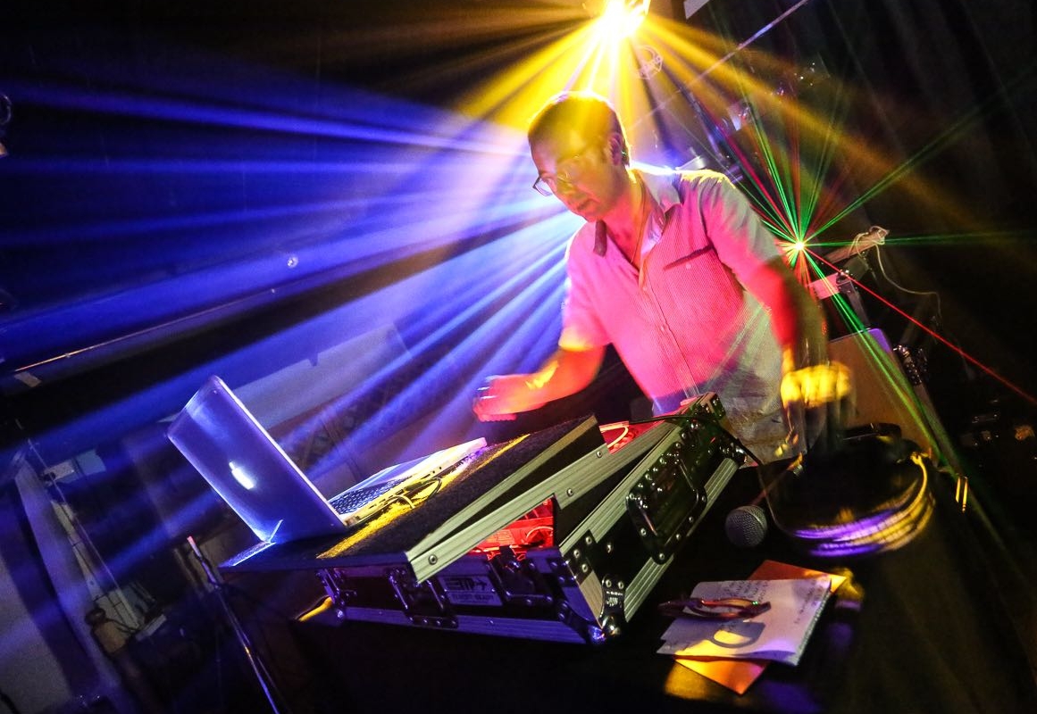 Picture of a DJ playing with a Sax and Bongo Player