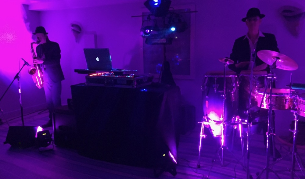Image of a DJ setup with Sax and Bongos