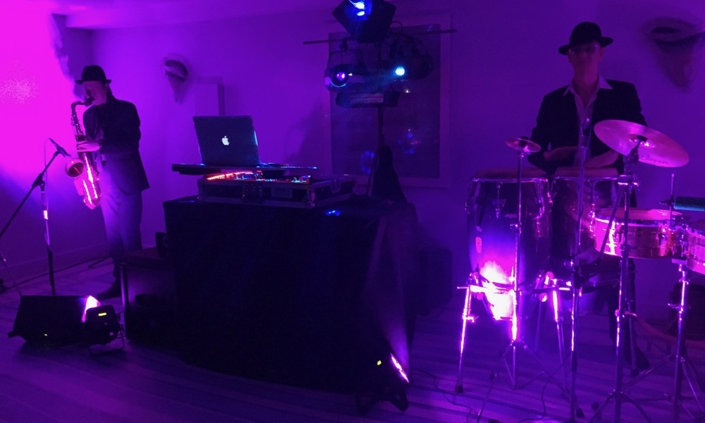 Image of a DJ setup with Sax and Bongos