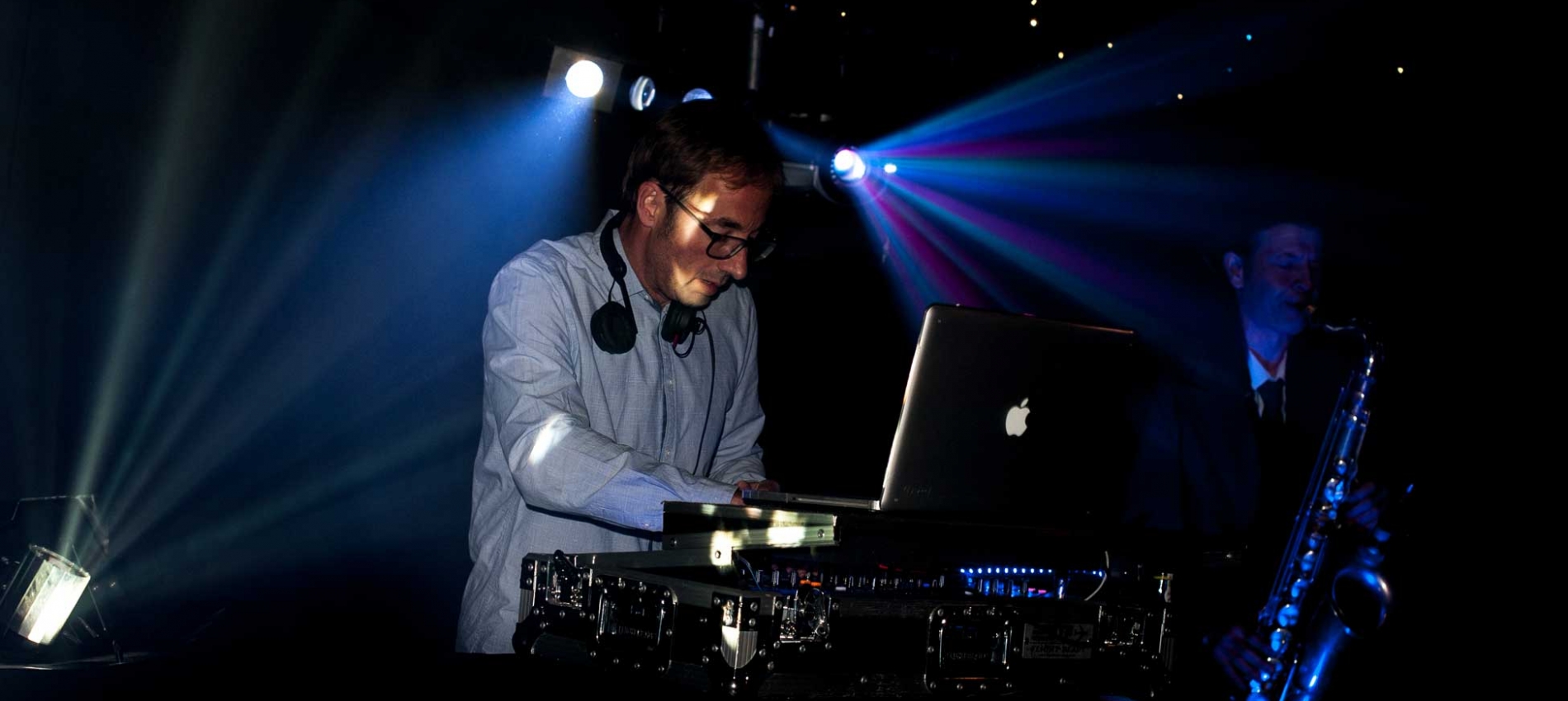 Picture of a DJ playing with a Sax and Bongo Player